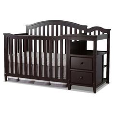 a baby crib with two drawers underneath it