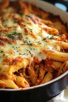 a casserole dish with pasta and cheese on the top is ready to be eaten