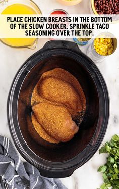 an overhead view of food in the crock pot and ingredients on the counter top