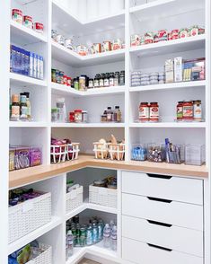 an organized pantry with white shelving and lots of food