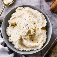 a bowl filled with mashed potatoes on top of a table