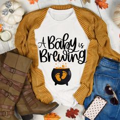 a baby is brewing t - shirt on top of some fall leaves and pumpkins