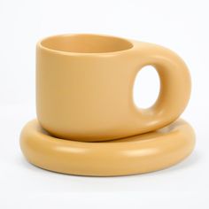 two yellow cups sitting on top of each other