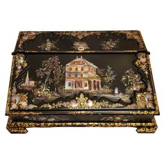 an ornately decorated black box with gold trimming