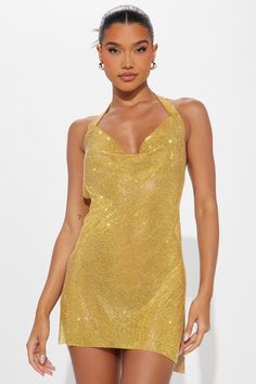 a woman wearing a gold sequin mini dress