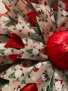 a christmas wreath with red and green ribbons