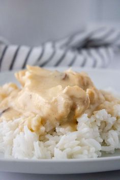 a white plate topped with rice covered in gravy