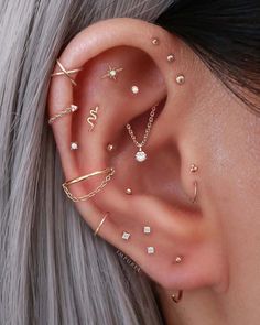 a woman with grey hair wearing ear piercings