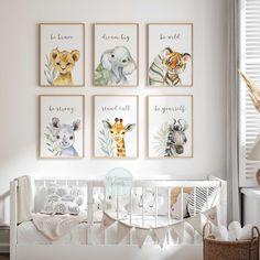 a baby's room with four framed pictures on the wall and a crib