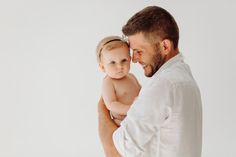 a man holding a baby in his arms