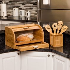 a loaf of bread is in an oven with utensils and spatulas