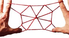 two hands are holding a red string net