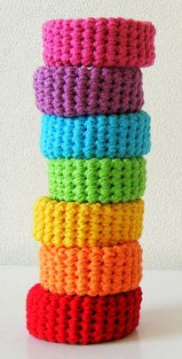 multicolored crocheted bracelets stacked on top of each other