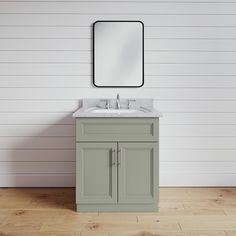 a bathroom sink with a mirror above it on the wall next to a wooden floor