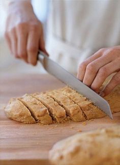 a person cutting bread with a large knife