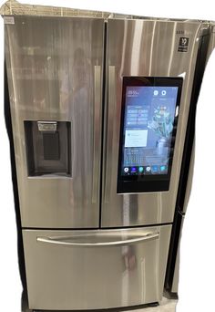 a stainless steel refrigerator with a touch screen on it