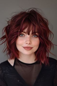 This haircut combines the trendy  hairstyle with shaggy layers, creating a look that is both edgy and effortlessly chic. Short Hairstyle Women Colored Hair, Plus Size Lob Haircut, Red Bob With Bangs, Bob With Bangs Round Face, Shaggy Lob Haircut, Short Burgundy Hair, Black And Red Hair, Corte Shaggy