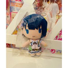 an anime doll with blue hair is on display