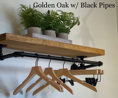 wooden clothes hangers and potted plants on a shelf