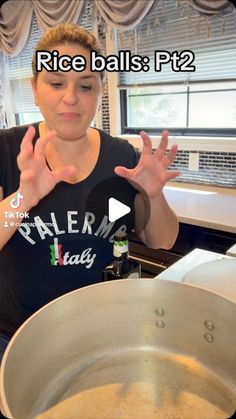 a woman standing in front of a frying pan with her hands out to the side