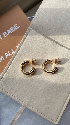 Our best-selling gold hoops! This lightweight, mini hoop features an open hoop design in your choice of silver or gold color. Add this earring to your stack with another set of hoops to stand out. Wear with jeans and a tee to style up an outfit, instantly elevating your style. Details: -Hollow lightweight metal tube hoops perfect for everyday wear -Sold as a pair Chic Small Hoop Tarnish Resistant Huggie Earrings, Chic Tarnish-resistant Small Hoop Huggie Earrings, Trendy Small Hoop Tarnish Resistant Earrings, Trendy Nickel-free Yellow Gold Hoop Earrings, Trendy Yellow Gold Nickel-free Hoop Earrings, Trendy Single Small Hoop Earring, Gold Trendy Earrings For Everyday, Gold Trendy Everyday Earrings, Gold Everyday Trendy Earrings