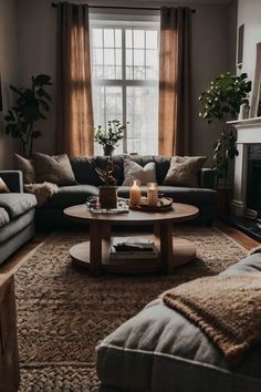 a living room with two couches and a coffee table in front of a fire place