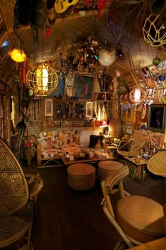 a room filled with lots of wicker furniture and hanging decorations on the ceiling above