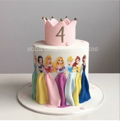 there is a cake with princesses on it and the number four in the middle