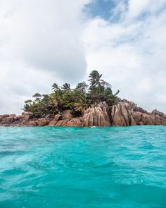 an island in the ocean with trees on it