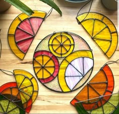 colorful stained glass pieces are arranged on a wooden surface