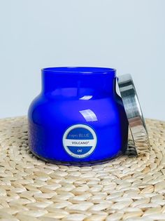 a blue candle sitting on top of a straw hat