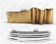 gold and white plates stacked on top of each other in front of a white background