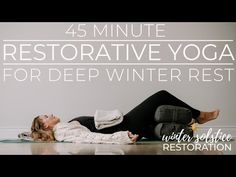 a woman laying on the floor in front of a wall with text that reads, 45 minute restorative yoga for deep winter rest