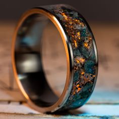 a wedding ring that has been made to look like it is covered in gold and green marble