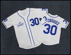 two baseball jerseys with the number 30 on them are laying next to each other in front of a gray background