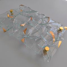 a broken glass table with some bottles on it