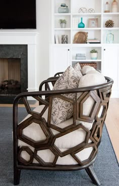 a living room filled with furniture and a flat screen tv mounted on a wall above a fireplace