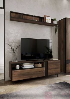 a living room with a large tv on top of a wooden entertainment center in front of a mirror