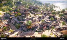 an aerial view of a village with palm trees and mountains in the background, surrounded by water