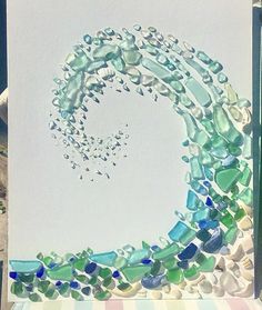 a painting made out of sea glass sitting on top of a table