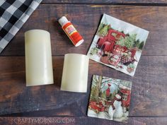 two candles and some napkins on a wooden table next to a bottle of glue