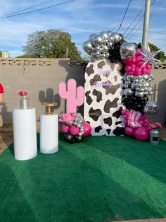 a cow themed party with balloons and decorations