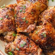 a plate full of chicken with parsley on the top and meat in the middle