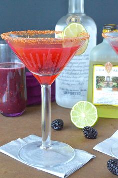 two martinis with raspberry and lime garnish