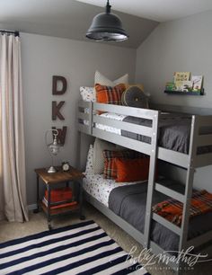 a bedroom with bunk beds and rugs on the floor