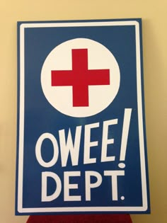 a sign that says owee dept with a red cross in the center on it