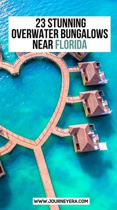 an aerial view of the ocean with overwater huts in the shape of a heart