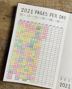 a page in a planner with numbers and times on the pages, sitting on a wooden table