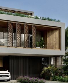 a white car is parked in front of a modern house with wooden shutters and balconies