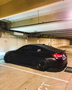 a black car parked in a parking garage